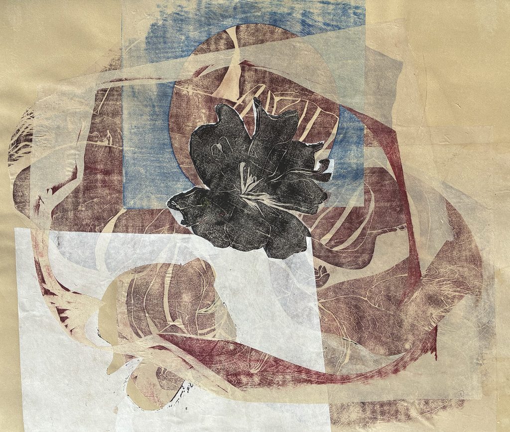 black blossom in the center surrounded by cut paper, two figures sleep in the background